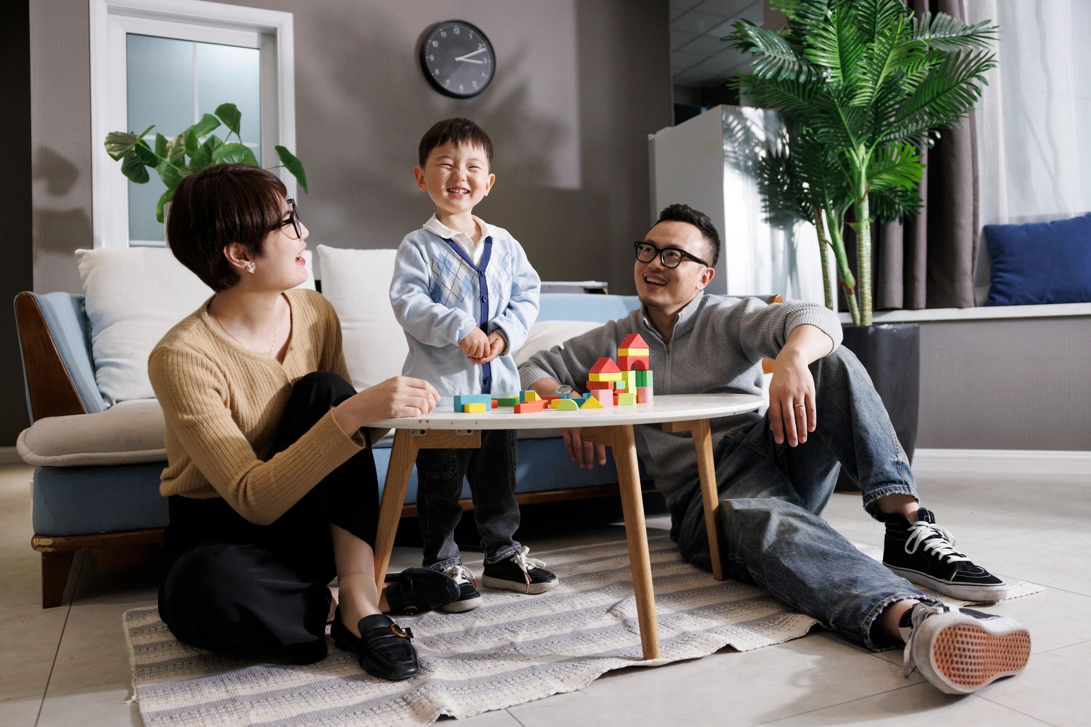 Parents and sons happily build blocks
