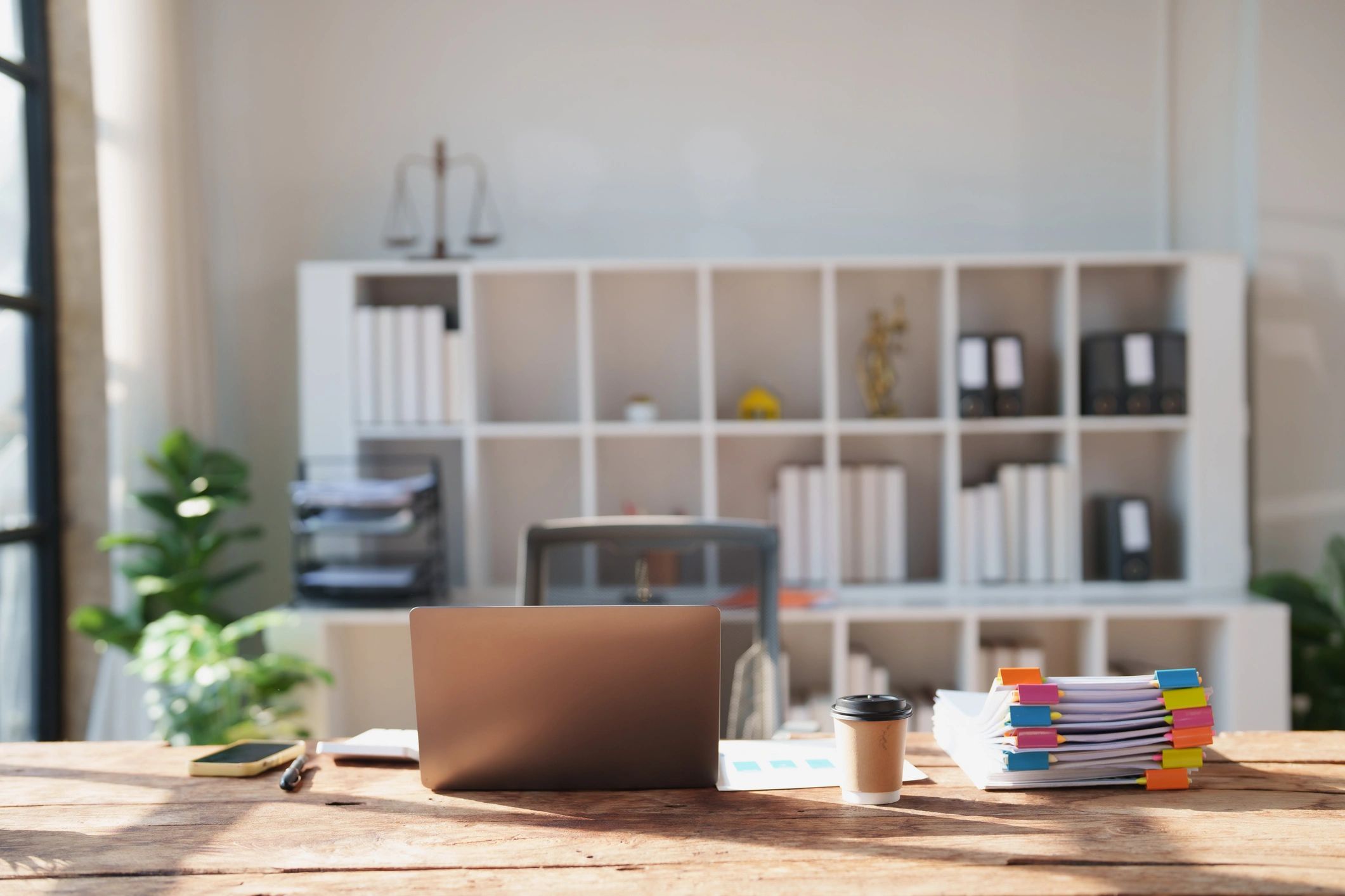 Law office desk with legal documents and laptop